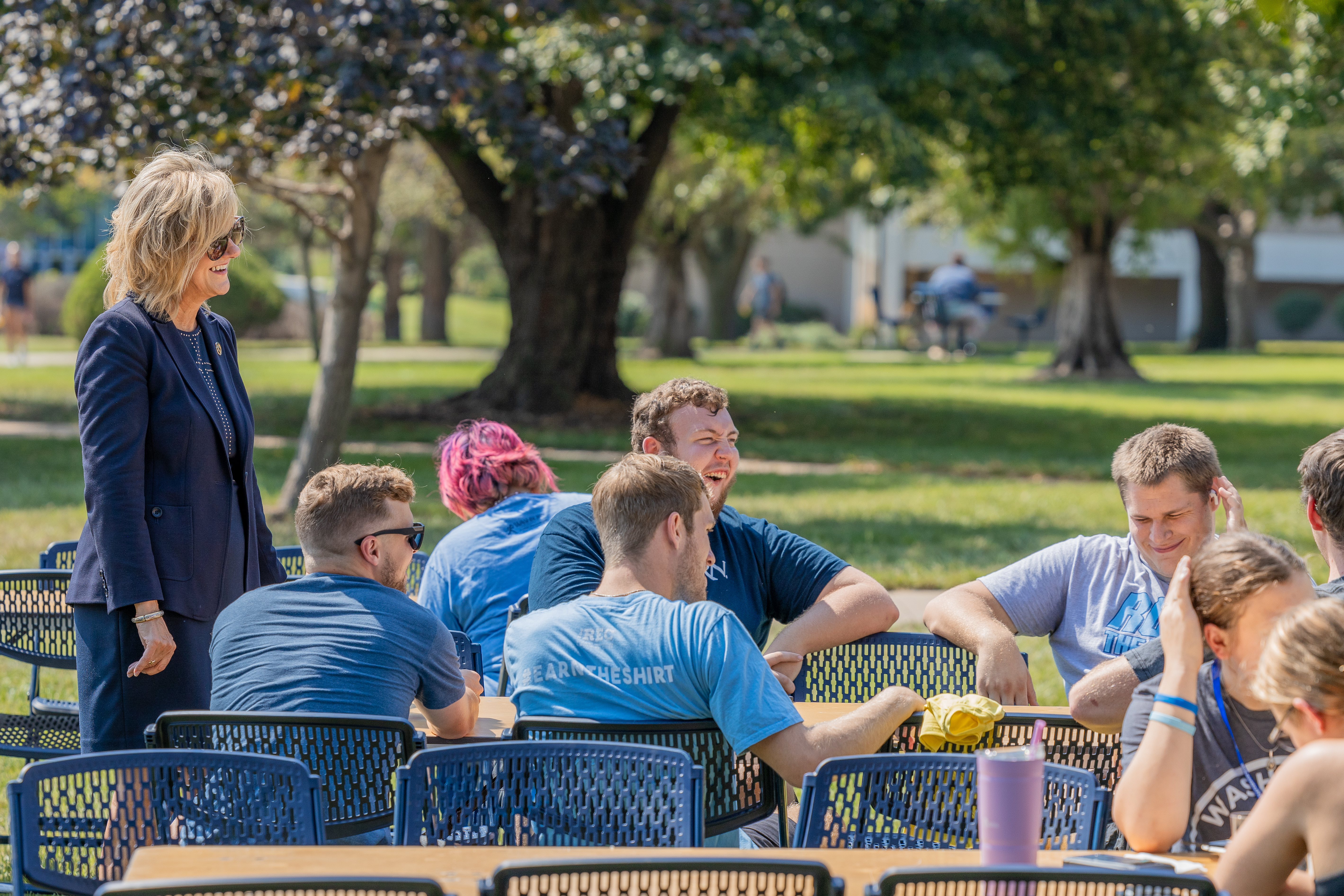 President Mazachek talks with a group of students during the President's Luncheon in August 2024.