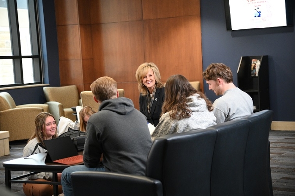 Dr. Mazachek and students in the Morgan Hall lobby