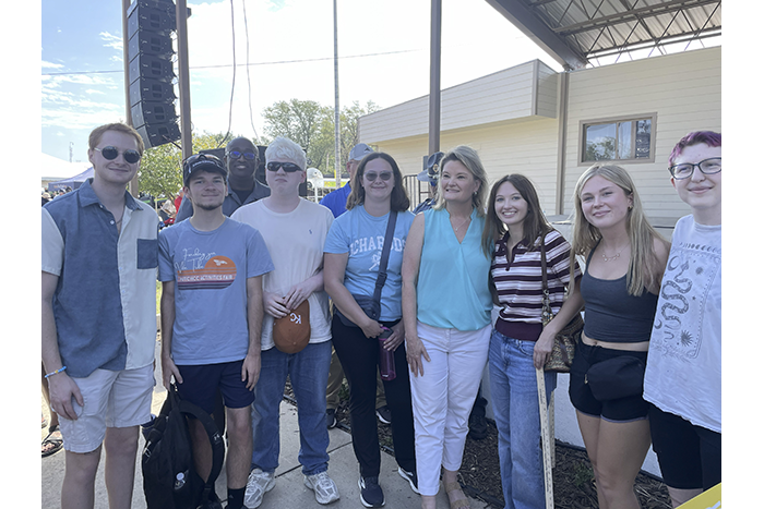 Eight Washburn students enrolled in the special topics course on the 2026 Kansas Elections pose with gubernatorial candidate Cindy Holscher.  
