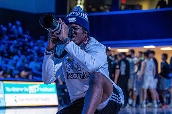 student shooting photographs
