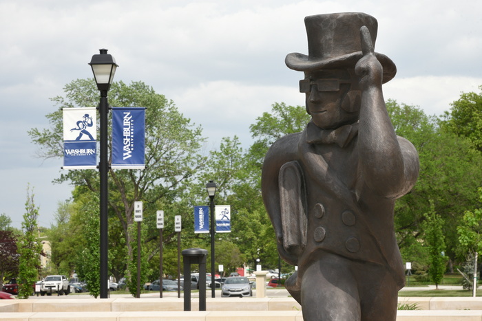 Metal Ichabod statue with Washburn banners in background